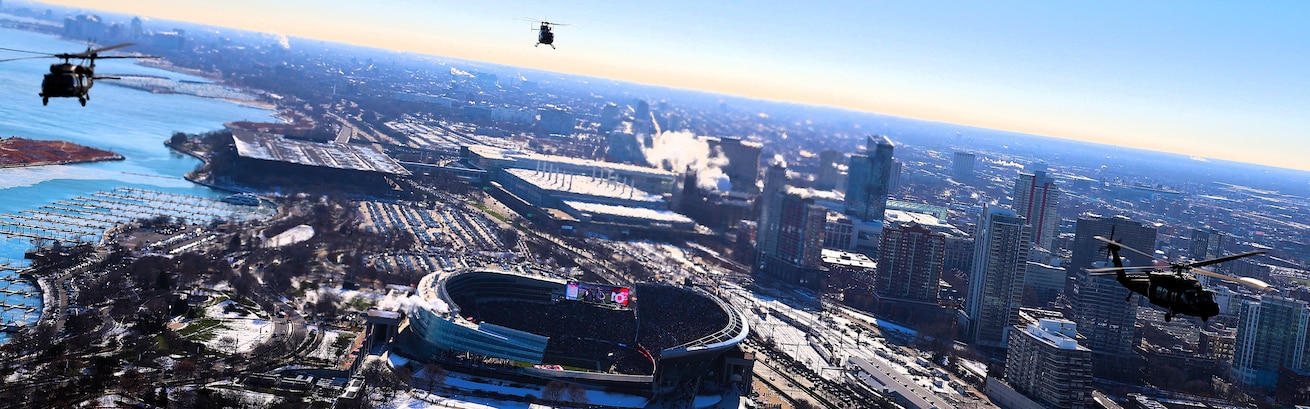 A diamond formation of Illinois Army National Guard helicopters performs a flyover over Soldier Field in Chicago on Dec. 14.