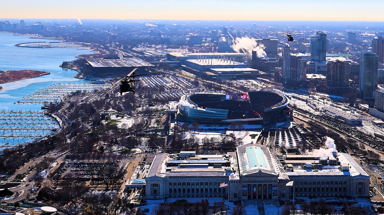 A diamond formation of Illinois Army National Guard helicopters performs a flyover over Soldier Field in Chicago on Dec. 14.