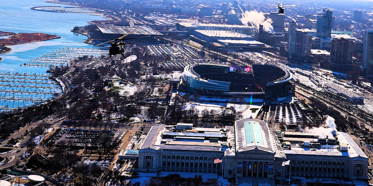 A diamond formation of Illinois Army National Guard helicopters performs a flyover over Soldier Field in Chicago on Dec. 14.