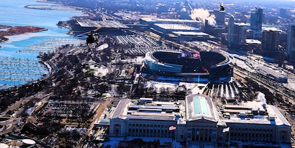 A diamond formation of Illinois Army National Guard helicopters performs a flyover over Soldier Field in Chicago on Dec. 14.