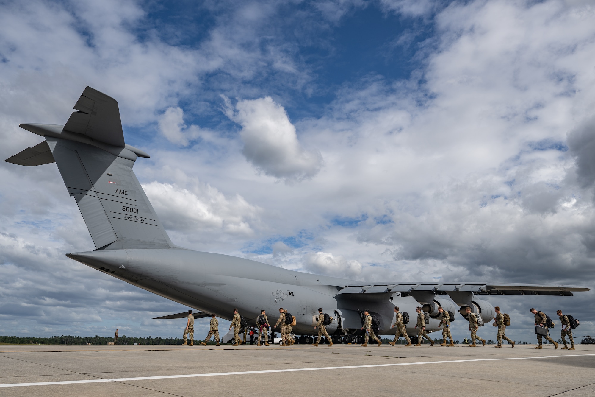 U.S. Air Force Airmen assigned to the 9th Airlift Squadron and 23rd Logistics Readiness Squadron load cargo from the 38th Rescue Squadron into a C-5M Super Galaxy at Moody Air Force Base, Georgia, Oct. 3, 2025.