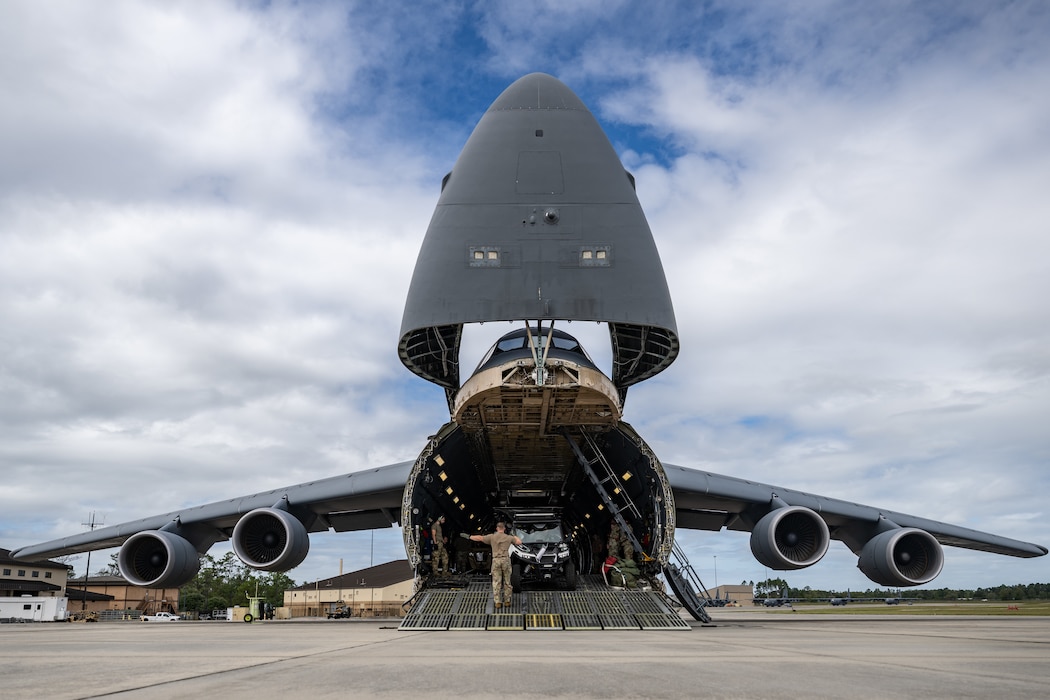 U.S. Air Force Airmen assigned to the 9th Airlift Squadron and 23rd Logistics Readiness Squadron load cargo from the 38th Rescue Squadron into a C-5M Super Galaxy at Moody Air Force Base, Georgia, Oct. 3, 2025.
