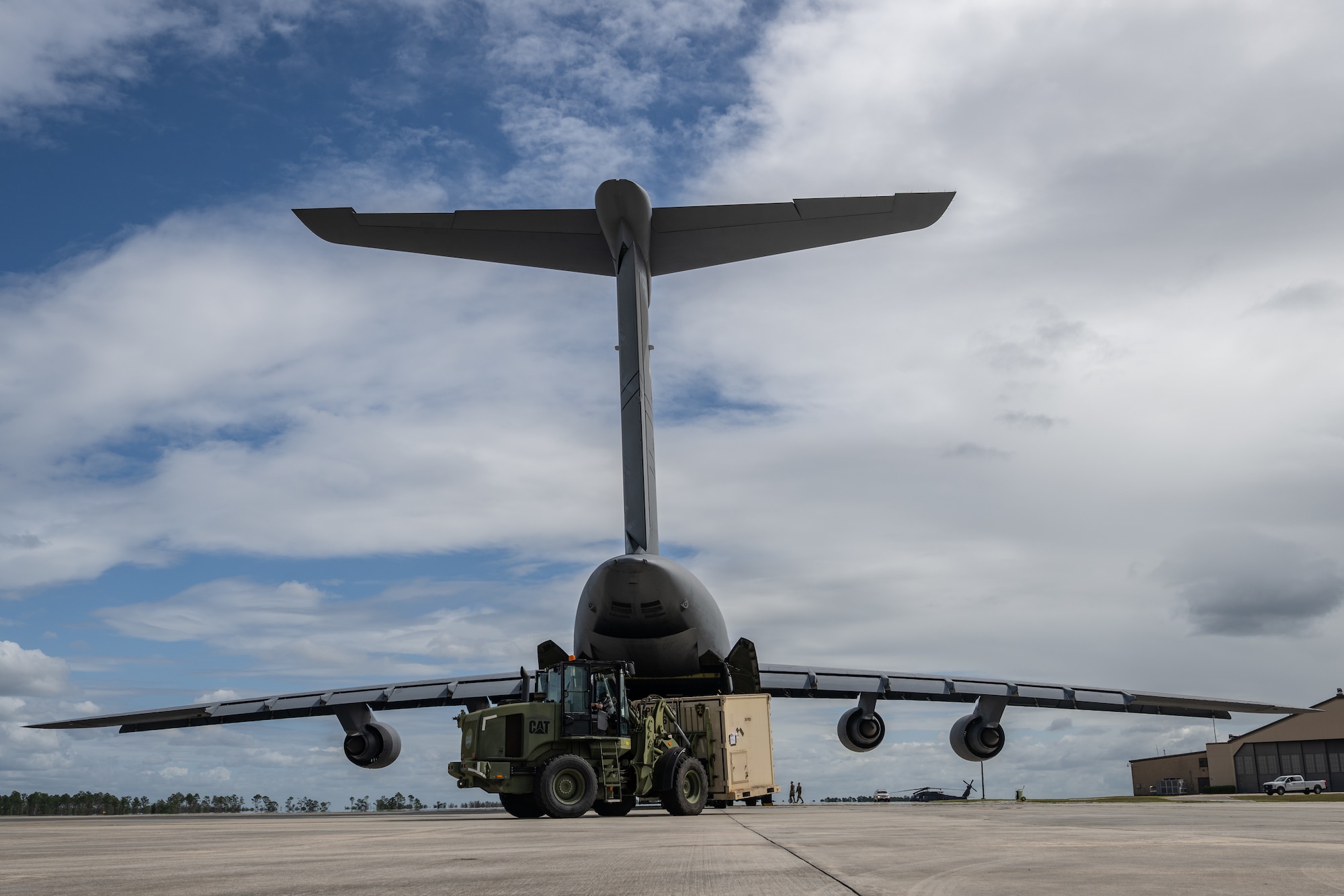 U.S. Air Force Airmen assigned to the 9th Airlift Squadron and 23rd Logistics Readiness Squadron load cargo from the 38th Rescue Squadron into a C-5M Super Galaxy at Moody Air Force Base, Georgia, Oct. 3, 2025.