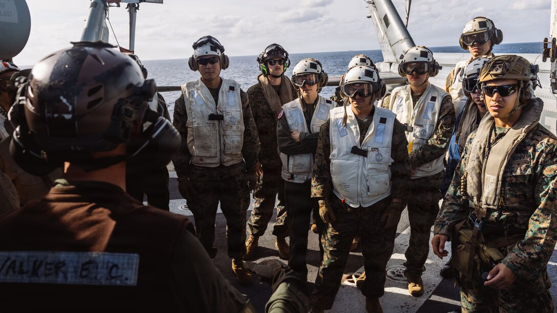 U.S. Marines and Navy Sailors with the 31st Marine Expeditionary Unit, listen to a Tactical Combat Casualty Care class aboard the forward-deployed amphibious assault carrier USS Tripoli (LHA 7), flagship of the Tripoli Expeditionary Strike Group, Dec. 6, 2025, while conducting routine operations in the U.S. 7th Fleet Area of Operations. The 31st MEU, the Marine Corps’ only continuously forward-deployed MEU, provides a flexible and lethal force ready to perform a wide range of military operations as the premiere crisis response force in the Indo-Pacific region. (U.S. Marine Corps photo by Lance Cpl. Raul Sotovilla)