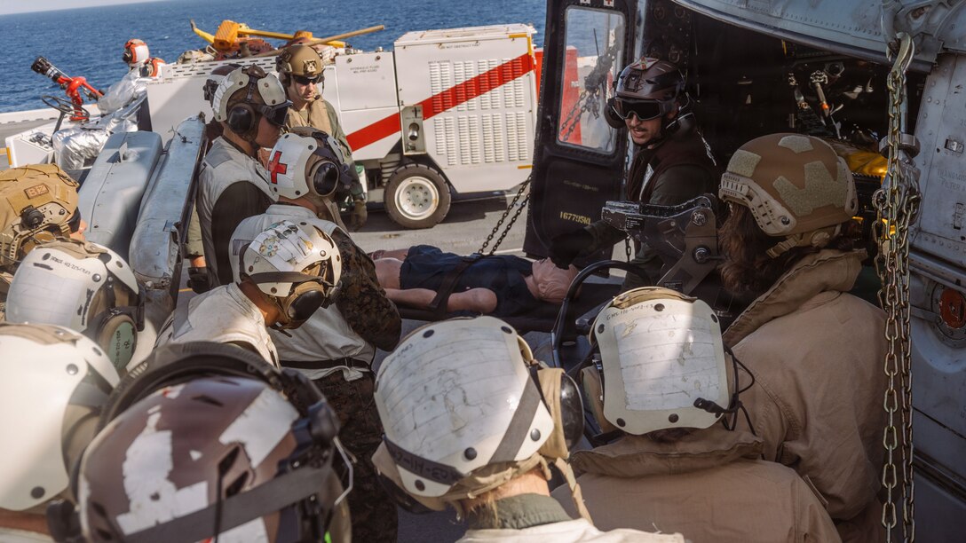 U.S. Marines and Navy Sailors with the 31st Marine Expeditionary Unit, listen to a Tactical Combat Casualty Care class aboard the forward-deployed amphibious assault carrier USS Tripoli (LHA 7), flagship of the Tripoli Expeditionary Strike Group, Dec. 6, 2025, while conducting routine operations in the U.S. 7th Fleet Area of Operations. The 31st MEU, the Marine Corps’ only continuously forward-deployed MEU, provides a flexible and lethal force ready to perform a wide range of military operations as the premiere crisis response force in the Indo-Pacific region. (U.S. Marine Corps photo by Lance Cpl. Raul Sotovilla)