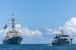 Arleigh Burke-class guided-missile destroyer USS Mahan (DDG 72), left, operates with Guyana Defence Force Defiant-class patrol vessel GDFS Shahous (1039) in the Caribbean Sea off the eastern coast of Guyana, Nov 22, 2025. U.S. military forces are deployed to the Caribbean in support of the U.S. Southern Command mission, Department of War-directed operations, and the president's priorities to disrupt illicit drug trafficking and protect the homeland. (U.S. Navy photo)