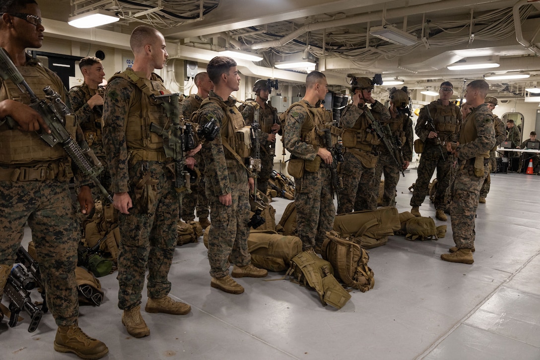 U.S. Marines with Weapons Company, Battalion Landing Team 3rd Battalion, 1st Marine Regiment, 31st Marine Expeditionary Unit, conduct gear checks aboard the forward-deployed amphibious assault carrier USS Tripoli (LHA 7), flagship of the Tripoli Expeditionary Strike Group, Dec. 3, 2025, while conducting routine operations in the U.S. 7th Fleet Area of Operations. Marines conducted call away drills in order to sustain mission capabilities in support of the 31st MEU. The 31st MEU, the Marine Corps’ only continuously forward-deployed MEU, provides a flexible and lethal force ready to perform a wide range of military operations as the premiere crisis response force in the Indo-Pacific region. (U.S. Marine Corps photo by Lance Cpl. Raul Sotovilla)