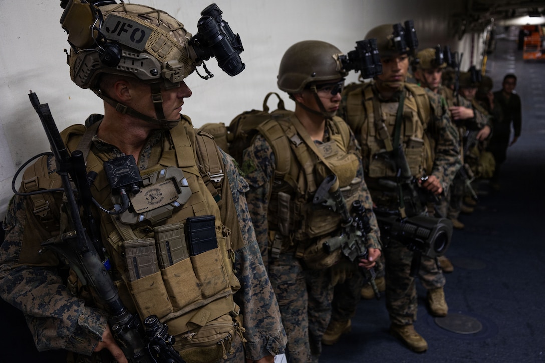 U.S. Marines with Weapons Company, Battalion Landing Team 3rd Battalion, 1st Marine Regiment, 31st Marine Expeditionary Unit, stage before a mission aboard the forward-deployed amphibious assault carrier USS Tripoli (LHA 7), flagship of the Tripoli Expeditionary Strike Group, Dec. 3, 2025, while conducting routine operations in the U.S. 7th Fleet Area of Operations. Marines conducted call away drills in order to sustain mission capabilities in support of the 31st MEU. The 31st MEU, the Marine Corps’ only continuously forward-deployed MEU, provides a flexible and lethal force ready to perform a wide range of military operations as the premiere crisis response force in the Indo-Pacific region. (U.S. Marine Corps photo by Lance Cpl. Raul Sotovilla)