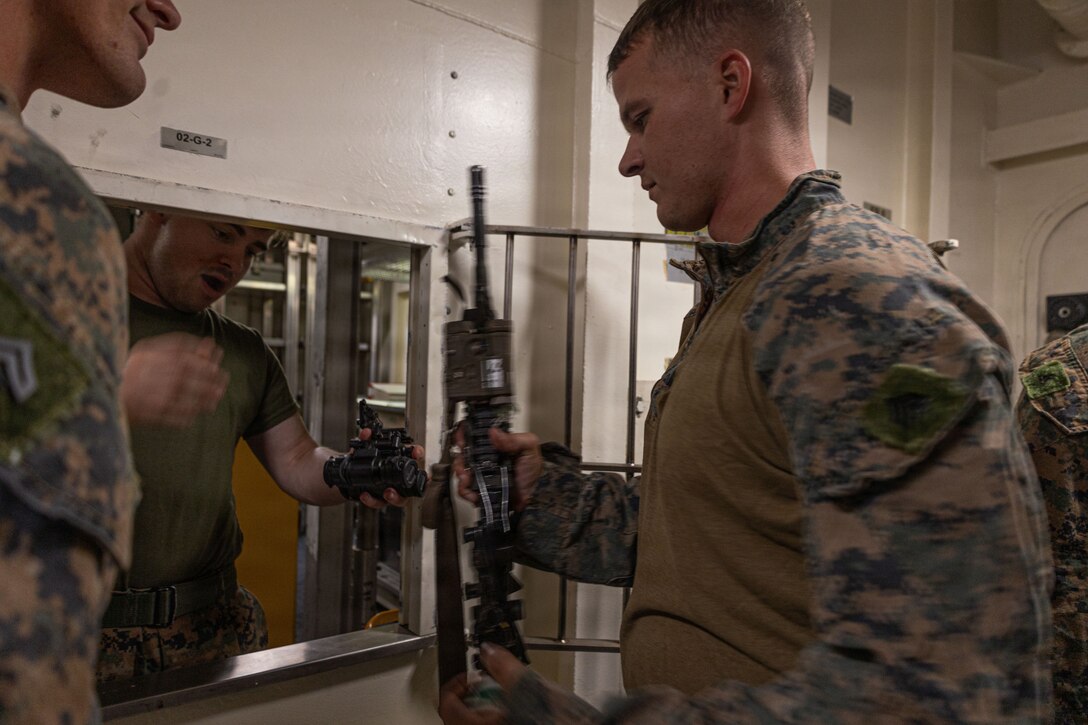 A U.S. Marine with Weapons Company, Battalion Landing Team 3rd Battalion, 1st Marine Regiment, 31st Marine Expeditionary Unit, draws an M4 Carbine from the armory aboard the forward-deployed amphibious assault carrier USS Tripoli (LHA 7), flagship of the Tripoli Expeditionary Strike Group, Dec. 3, 2025, while conducting routine operations in the U.S. 7th Fleet Area of Operations. Marines conducted call away drills in order to sustain mission capabilities in support of the 31st MEU. The 31st MEU, the Marine Corps’ only continuously forward-deployed MEU, provides a flexible and lethal force ready to perform a wide range of military operations as the premiere crisis response force in the Indo-Pacific region. (U.S. Marine Corps photo by Lance Cpl. Raul Sotovilla)