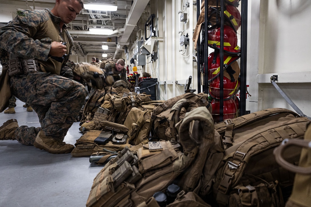 U.S. Marines with Weapons Company, Battalion Landing Team 3rd Battalion, 1st Marine Regiment, 31st Marine Expeditionary Unit, conduct gear checks aboard the forward-deployed amphibious assault carrier USS Tripoli (LHA 7), flagship of the Tripoli Expeditionary Strike Group, Dec. 3, 2025, while conducting routine operations in the U.S. 7th Fleet Area of Operations. Marines conducted call away drills in order to sustain mission capabilities in support of the 31st MEU. The 31st MEU, the Marine Corps’ only continuously forward-deployed MEU, provides a flexible and lethal force ready to perform a wide range of military operations as the premiere crisis response force in the Indo-Pacific region. (U.S. Marine Corps photo by Lance Cpl. Raul Sotovilla)