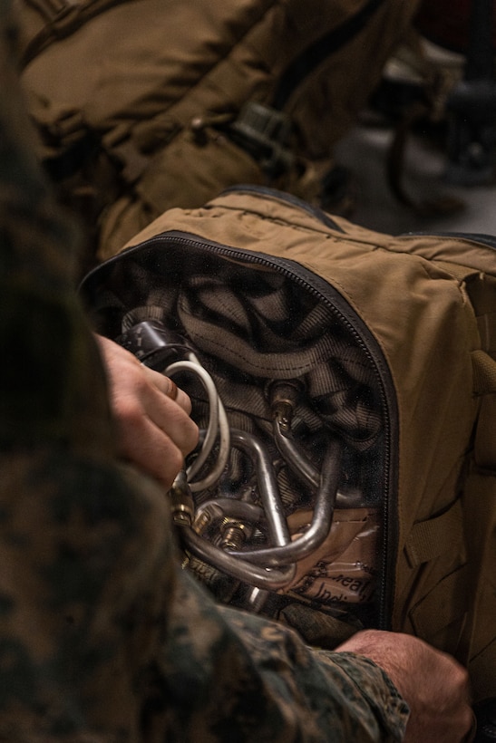 A U.S. Marine with Weapons Company, Battalion Landing Team 3rd Battalion, 1st Marine Regiment, 31st Marine Expeditionary Unit, stores gear aboard the forward-deployed amphibious assault carrier USS Tripoli (LHA 7), flagship of the Tripoli Expeditionary Strike Group, Dec. 3, 2025, while conducting routine operations in the U.S. 7th Fleet Area of Operations. The 31st MEU, the Marine Corps’ only continuously forward-deployed MEU, provides a flexible and lethal force ready to perform a wide range of military operations as the premiere crisis response force in the Indo-Pacific region. (U.S. Marine Corps photo by Lance Cpl. Raul Sotovilla)