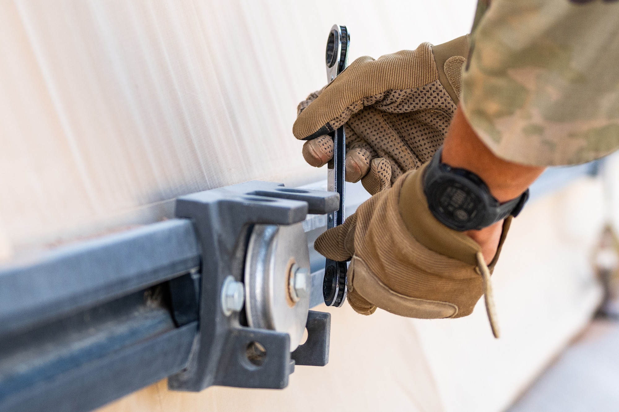 U.S. Air Force Senior Airman Austin Kirk, and Airman 1st Class Sean Stark, 378th Expeditionary Civil Engineer Squadron structural maintenance journeymen, inspect tension fabric systems on large area maintenance shelters
