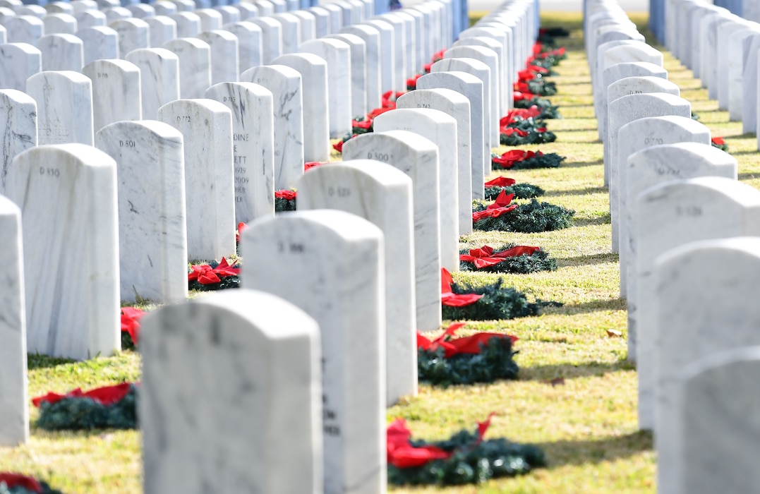 Wreaths lay at the foot of gravestones.
