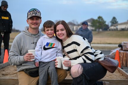 U.S. Air Force Tech. Sgt. Trenton Ballard, his wife, U.S. Air Force Tech. Sgt. Erika Ballard, and their son, Carson, pose for a family photo at Winterfest on Joint Base Anacostia-Bolling, Washington, D.C., Dec. 6, 2025. The event featured a boat parade, various vendors, a bonfire, Santa Claus and a holiday light display. (U.S. Air Force photo by Airman 1st Class Shanel Toussaint)