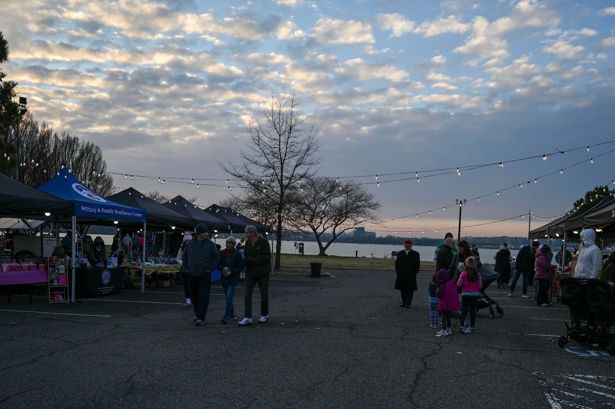 Families enjoy the Winterfest celebration at the Slip Inn on Joint Base Anacostia-Bolling, Washington, D.C., Dec. 6, 2025. The event featured a boat parade, various vendors, a bonfire, Santa Claus and a holiday light display. (U.S. Air Force photo by Airman 1st Class Shanel Toussaint)