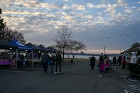 Families enjoy the Winterfest celebration at the Slip Inn on Joint Base Anacostia-Bolling, Washington, D.C., Dec. 6, 2025. The event featured a boat parade, various vendors, a bonfire, Santa Claus and a holiday light display. (U.S. Air Force photo by Airman 1st Class Shanel Toussaint)