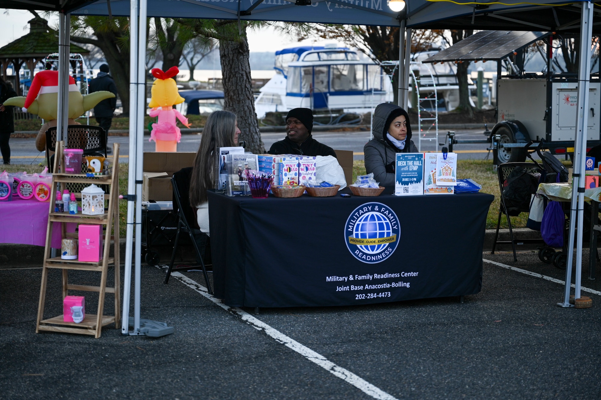 Military Family Readiness Center staff prepare for visitors during the Winterfest celebration at Joint Base Anacostia-Bolling, Washington, D.C., Dec. 6, 2025. The 811th FSS hosted the event in support of their mission to provide family support to Airmen in the National Capital Region. (U.S. Air Force photo by Airman 1st Class Shanel Toussaint)