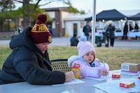 McKayla Kerr, left, and her daughter, Elizabeth, color together during the Winterfest celebration at Joint Base Anacostia-Bolling, Washington, D.C., Dec. 6, 2025. The event featured a boat parade, various vendors, a bonfire, Santa Claus and a holiday light display. (U.S. Air Force photo by Airman 1st Class Shanel Toussaint)