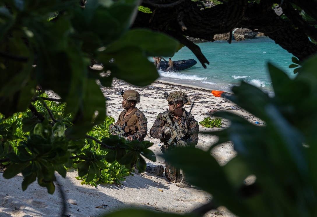 U.S. Marine Corps Lance Cpl. Ryan Davis (left) and Sgt. Bo Olson, both riflemen with India Company, Battalion Landing Team 3rd Battalion, 1st Marine Regiment, 31st Marine Expeditionary Unit, set security during a small boat raid as part of MEU Exercise in Okinawa, Japan, Dec. 3, 2025. This training aimed to enhance the Marines ability to conduct boat raids using the enhanced combat rubber reconnaissance craft. The 31st MEU, the Marine Corps’ only continuously forward deployed MEU, provides a flexible and lethal force, ready to perform a wide range of military operations as the premiere crisis response force in the Indo-Pacific region. (U.S. Marine Corps photo by Cpl. Rebeka Falcon)