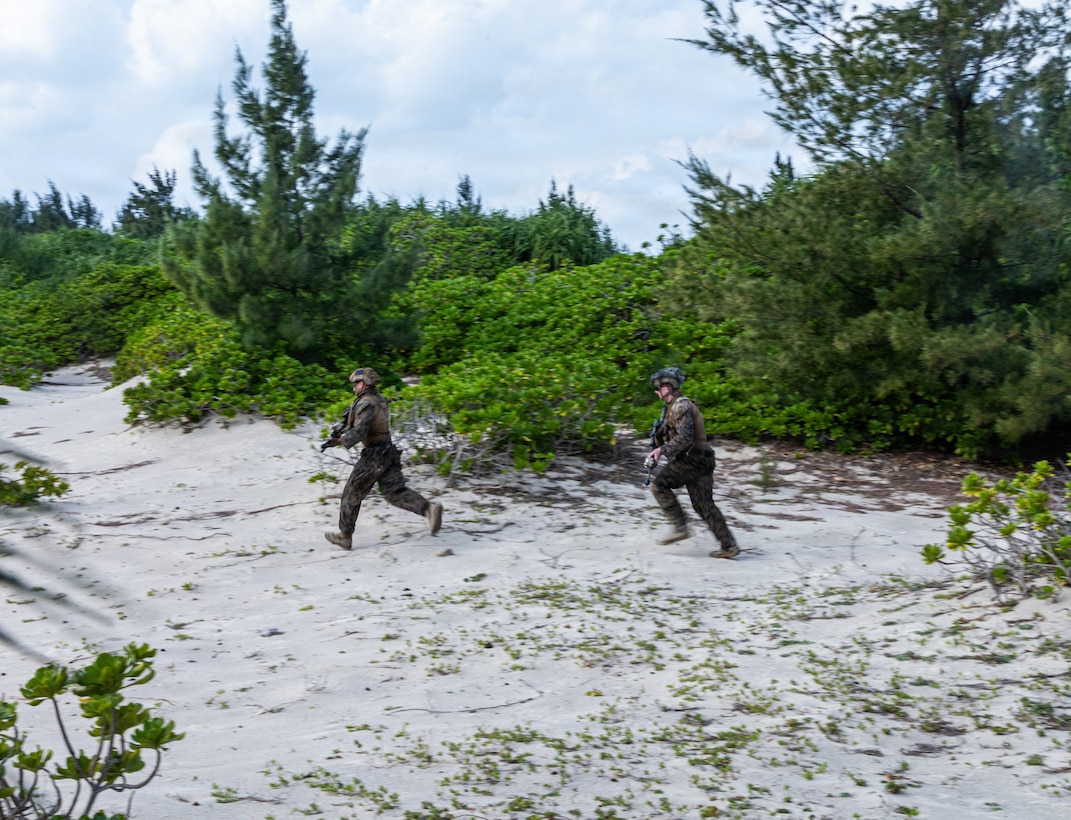 U.S. Marines with India Company, Battalion Landing Team 3rd Battalion, 1st Marine Regiment, 31st Marine Expeditionary Unit, conduct a buddy rush during a small boat raid as part of MEU Exercise in Okinawa, Japan, Dec. 3, 2025. This training aimed to enhance the Marines ability to conduct boat raids using the enhanced combat rubber reconnaissance craft. The 31st MEU, the Marine Corps’ only continuously forward deployed MEU, provides a flexible and lethal force, ready to perform a wide range of military operations as the premiere crisis response force in the Indo-Pacific region. (U.S. Marine Corps photo by Cpl. Rebeka Falcon)