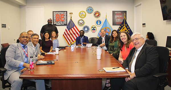 People sitting around a conference room table.