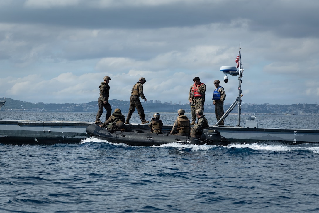 U.S. Marines with India Company, Battalion Landing Team 3rd Battalion, 1st Marine Regiment, 31st Marine Expeditionary Unit, conduct a simulated resupply with supplies from an autonomous low-profile vessel to during unmanned surface vessel training operations as part of MEU Exercise at White Beach Naval Facility, Okinawa, Japan on Dec. 2, 2025. The ALPV has the ability to deliver multiple variations of supplies and equipment through contested maritime terrain. The 31st MEU, the Marine Corps’ only continuously forward deployed MEU, provides a flexible and lethal force, ready to perform a wide range of military operations as the premiere crisis response force in the Indo-Pacific region. (U.S. Marine Corps photo by Sgt. Alora Finigan)