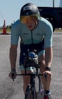 John Kremar, NSWC PCD Diving and Life Support lead engineer, rides his bicycle during IRONMAN Florida 2025, Nov. 1. This event was a series of long-distance triathlon races consisting of a 2.4-mile swim, a 112-mile bike ride, and a marathon 26.2-mile run, totaling 140.6 miles. (courtesy photo)
