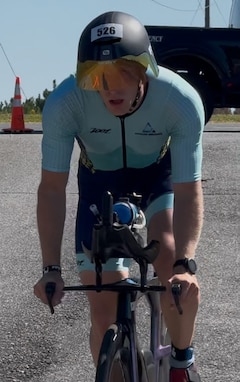John Kremar, NSWC PCD Diving and Life Support lead engineer, rides his bicycle during IRONMAN Florida 2025, Nov. 1. This event was a series of long-distance triathlon races consisting of a 2.4-mile swim, a 112-mile bike ride, and a marathon 26.2-mile run, totaling 140.6 miles. (courtesy photo)