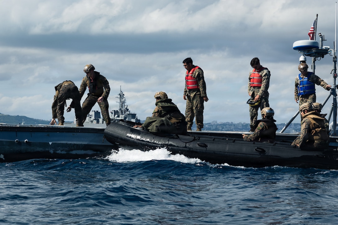 U.S. Marines with India Company, Battalion Landing Team 3rd Battalion, 1st Marine Regiment, 31st Marine Expeditionary Unit, conduct a simulated resupply with supplies from an autonomous low-profile vessel to during unmanned surface vessel training operations as part of MEU Exercise at White Beach Naval Facility, Okinawa, Japan on Dec. 2, 2025. The ALPV has the ability to deliver multiple variations of supplies and equipment through contested maritime terrain. The 31st MEU, the Marine Corps’ only continuously forward deployed MEU, provides a flexible and lethal force, ready to perform a wide range of military operations as the premiere crisis response force in the Indo-Pacific region. (U.S. Marine Corps photo by Sgt. Alora Finigan)