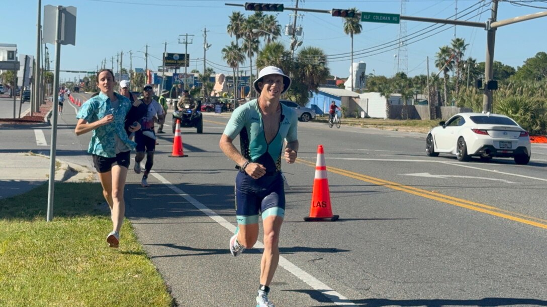 John Kremar, NSWC PCD Diving and Life Support lead engineer, gets closer to completing the final leg of the IRONMAN Florida 2025 triathlon, Nov. 1. He completed the competition in under 9 hours, which is something only 95 amateurs have achieved throughout this event’s history. (courtesy photo)