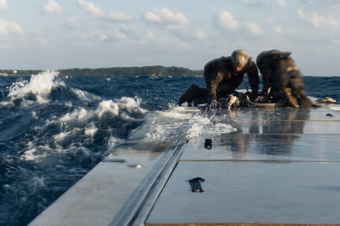 U.S. Marines with India Company, Battalion Landing Team 3rd Battalion, 1st Marine Regiment, 31st Marine Expeditionary Unit, conduct an at sea resupply drill with supplies from an autonomous low-profile vessel during unmanned surface vessel training operations as part of MEU Exercise at White Beach Naval Facility, Okinawa, Japan on Dec. 3, 2025. The ALPV has the ability to deliver multiple variations of supplies and equipment through contested maritime terrain. The 31st MEU, the Marine Corps’ only continuously forward deployed MEU, provides a flexible and lethal force, ready to perform a wide range of military operations as the premiere crisis response force in the Indo-Pacific region. (U.S. Marine Corps photo by Sgt. Alora Finigan)