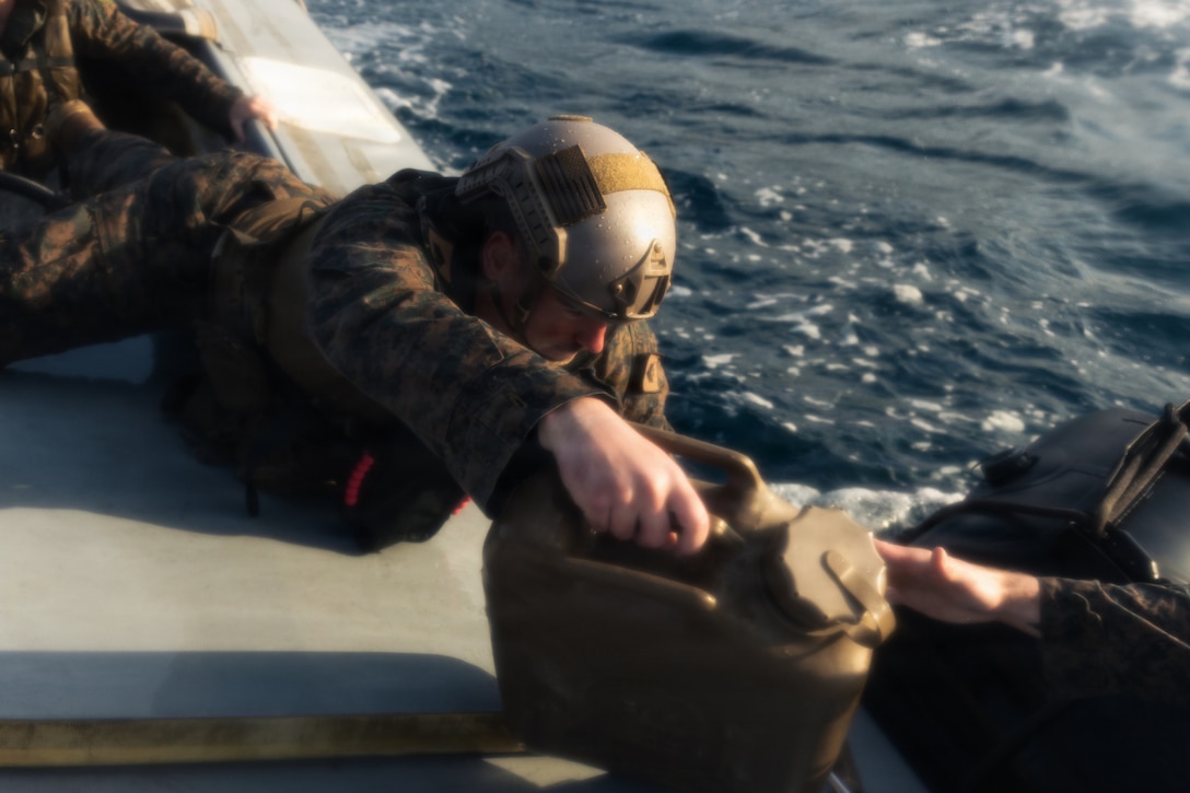 U.S. Marines with India Company, Battalion Landing Team 3rd Battalion, 1st Marine Regiment, 31st Marine Expeditionary Unit, conduct an at sea resupply drill with supplies from an autonomous low-profile vessel during unmanned surface vessel training operations as part of MEU Exercise at White Beach Naval Facility, Okinawa, Japan on Dec. 3, 2025. The ALPV has the ability to deliver multiple variations of supplies and equipment through contested maritime terrain. The 31st MEU, the Marine Corps’ only continuously forward deployed MEU, provides a flexible and lethal force, ready to perform a wide range of military operations as the premiere crisis response force in the Indo-Pacific region. (U.S. Marine Corps photo by Sgt. Alora Finigan)