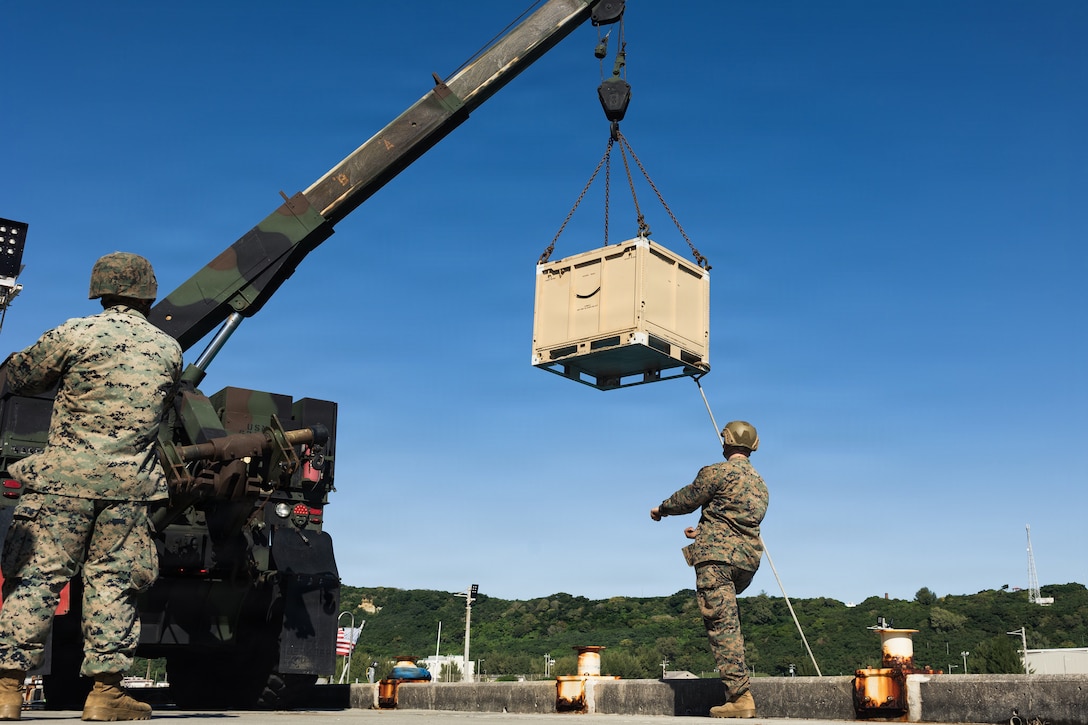 U.S. Marines with Combat Logistics Battalion 31, 31st Marine Expeditionary Unit, load joint modular intermodal containers onto an autonomous low-profile vessel during unmanned surface vessel training operations as part of MEU Exercise at White Beach Naval Facility, Okinawa, Japan on Dec. 2, 2025. The ALPV has the ability to deliver multiple variations of supplies and equipment through contested maritime terrain. The 31st MEU, the Marine Corps’ only continuously forward deployed MEU, provides a flexible and lethal force, ready to perform a wide range of military operations as the premiere crisis response force in the Indo-Pacific region. (U.S. Marine Corps photo by Sgt. Alora Finigan)