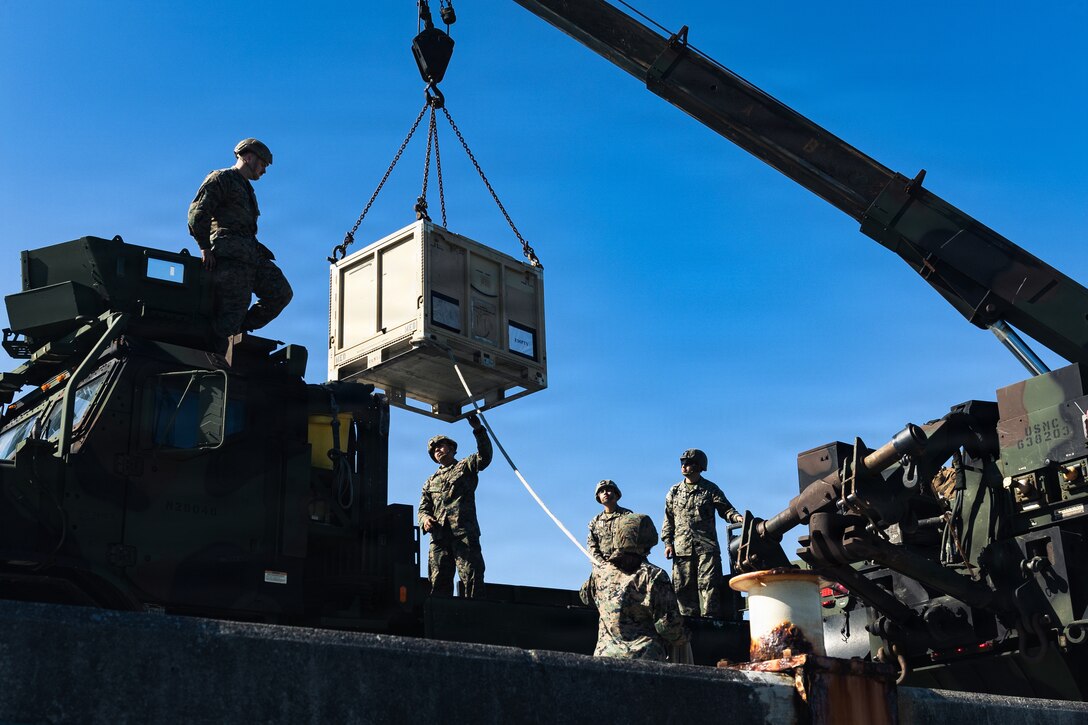U.S. Marines with Combat Logistics Battalion 31, 31st Marine Expeditionary Unit, prepare to load joint modular intermodal containers onto an autonomous low-profile vessel during unmanned surface vessel training operations as part of MEU Exercise at White Beach Naval Facility, Okinawa, Japan on Dec. 2, 2025. The ALPV has the ability to deliver multiple variations of supplies and equipment through contested maritime terrain. The 31st MEU, the Marine Corps’ only continuously forward deployed MEU, provides a flexible and lethal force, ready to perform a wide range of military operations as the premiere crisis response force in the Indo-Pacific region. (U.S. Marine Corps photo by Sgt. Alora Finigan)