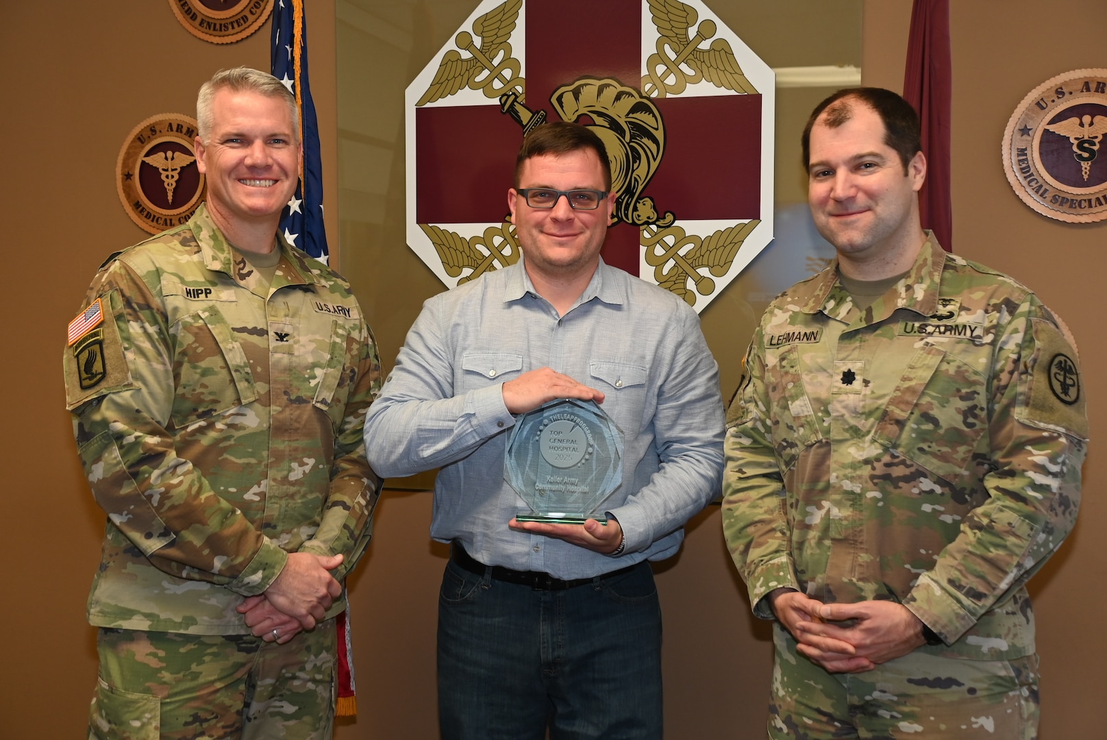 Mr. Collin Speed, Col. Sean J. Hipp, and Lt. Col. Thomas Lehmann display the 2025 Top General Hospital award.