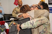 U.S. Air Force Tech. Sgt. Tomarra Woods, right, the noncommissioned officer in charge of outbound assignments, hugs Staff. Sgt. Samantha Gordon, the section chief of customer support, both with the 11th Military Personnel Flight, during Woods’ promotion ceremony on Joint Base Anacostia-Bolling, Washington, D.C., Nov. 25, 2025. Woods received the Stripes for Exceptional Performers promotion for her outstanding performance as an NCO at the 11th MPF. (U.S. Air Force photo by Hayden Hallman)