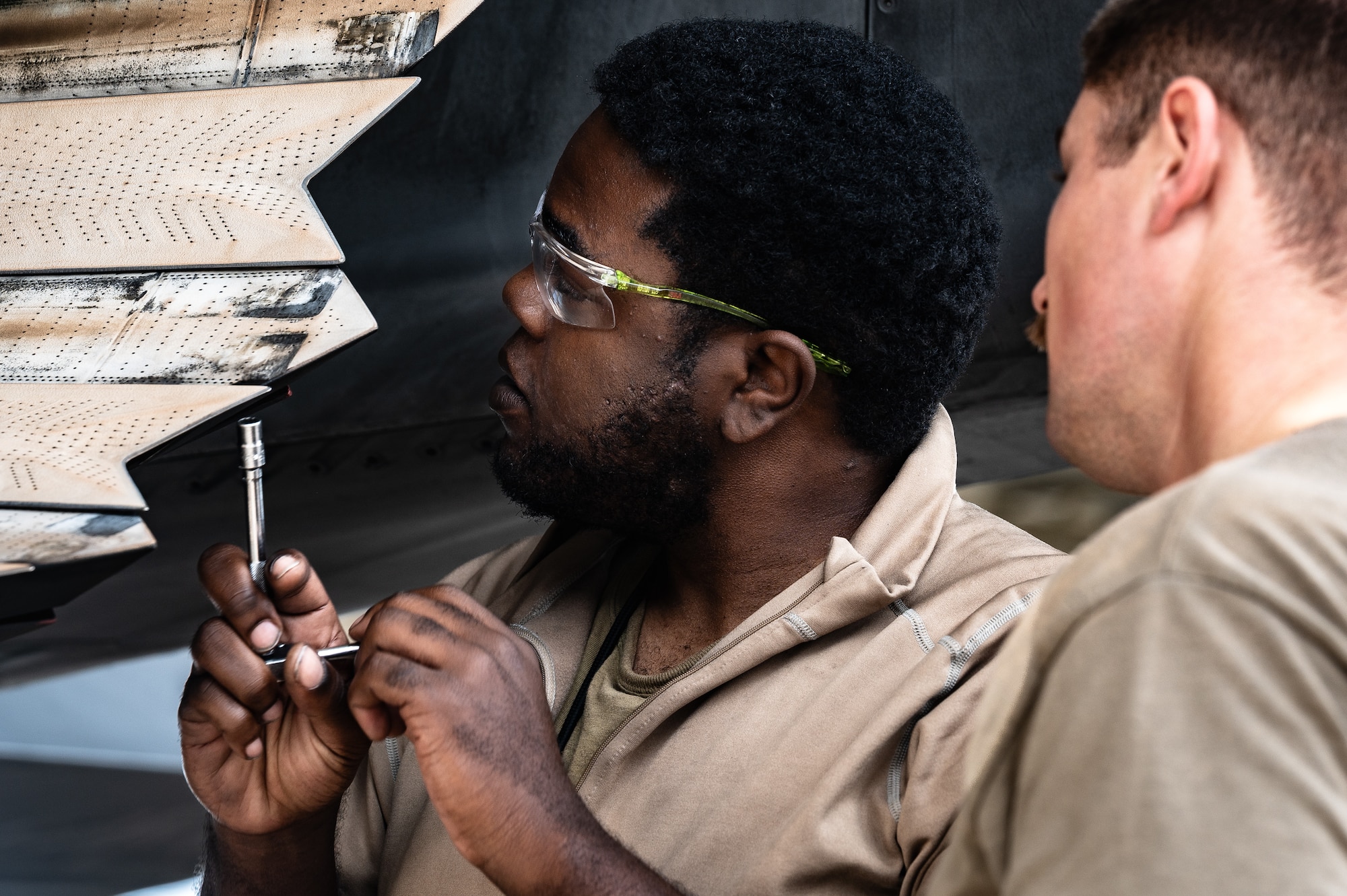U.S. Air Force Senior Airman Shannon Moore, 308th Aircraft Maintenance Unit F-35 tactical aircraft maintenance journeyman, conducts maintenance on the engine of an F-35A Lightning II