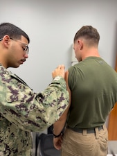 251204-N-FT324-9712. ROTA, Spain (Dec. 4, 2025) — Hospitalman Shalim Idrees, a corpsman assigned to Navy Medicine Readiness and Training Command (NMRTC) Rota, vaccinates a member of Marine Medium Tiltrotor Squadron 162 during the command’s annual influenza vaccination campaign, supporting Force Health Protection and operational readiness across the joint force. (U.S. Navy Photo by Lt. Cmdr. Alicia Sacks)