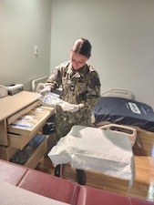 251201-N-FT324-4759. ROTA, Spain (December 1, 2025). Hospital Corpsman Third Class Aspen Eby, assigned to the Directorate of Surgical Services at U.S. Naval Hospital Rota, prepares for a procedure while supporting patient care in the OB/GYN clinic at Naval Station Rota, Spain. Eby’s work directly contributes to the medical readiness of service members and their families. (U.S. Navy Photo by Lt. Cmdr. Alicia Sacks)