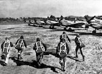 U.S. pilots assigned to the American Volunteer Group run toward their Curtiss P-40 Warhawk fighters to board for a mission in China. The group, later known as the Flying Tigers, became famous for their innovative tactics and shark-mouthed planes during World War II. (Courtesy Photo)