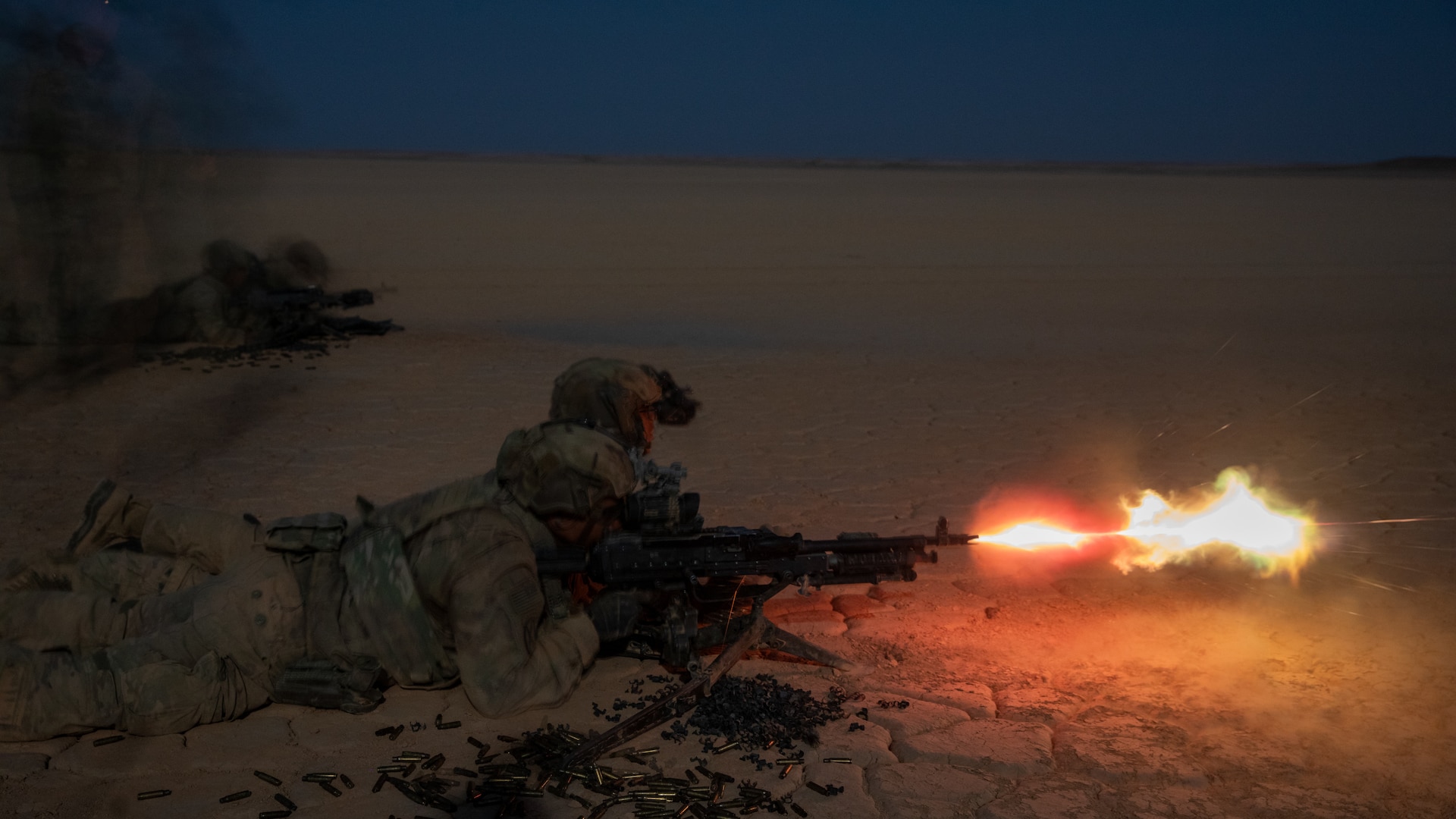 U.S. Army Infantrymen, assigned to 10th Mountain Division, Task Force ARMADILLO, fire an M240B machine gun during night range operations in Syria, June 9, 2025. Night range operations provide a tactical advantage over adversaries, enhancing operational and soldier readiness. The Coalition is committed to building partner capacity and capabilities in order to maintain the lasting defeat of ISIS.  (U.S. Army photo by Sgt. Trenton Pallone)