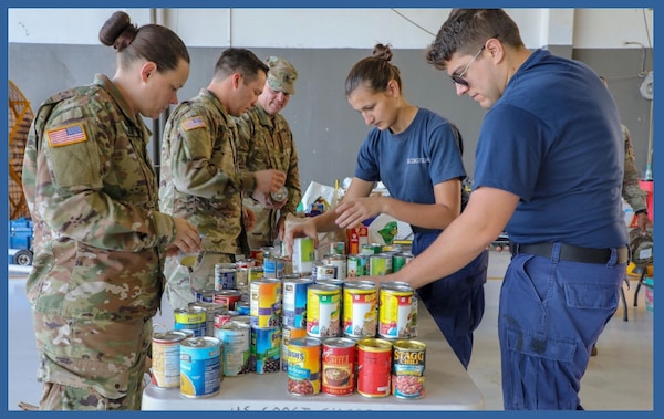 Pictured is the 25th Division Sustainment Brigade, 25th Infantry Division Soldiers, helping Coast Guard members sort and organize some of the 1,020 items donated January 29, 2019 at Barbers Point Naval Air Station, Hawaii, to help Coast Guard families in need after the 2018-2019 government shutdown. (Photo Credit: U.S. Army)