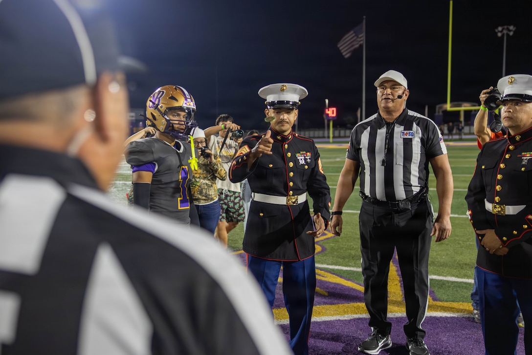 U.S. Marine Corps Staff Sgt. Gerardo Ocha, a recruiter with Recruiting Sub Station Weslaco, Recruiting Station South Texas,  performs the coin toss during a football game hosted by the Great American Rivalry series at Bobby Morrow Stadium in San Benito, Texas, Nov. 7, 2025. The Great American Rivalry Series high school football game, an event managed by Brainbox Intelligent Marketing that highlights some of the nation’s top football rivalries. Marines engaged with students and fans by hosting pull-up challenges, giving away t-shirts, and presenting awards to outstanding athletes and the winning team. (U.S. Marine Corps Photo by Cpl. Christian Salazar)