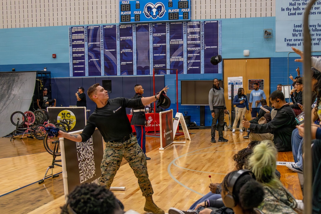 U.S. Marine Corps Sgt. Marco Razo, a recruiter with Recruiting Sub Station Westheimer, Recruiting Station South Texas, tosses prizes into stands during a pep rally at Elsik High School in Houston, Texas, Nov. 3, 2025. Now in its 25th year, the ASA NO Hate Tour is an educational program that uses the energy and excitement of action sports, including BMX demonstrations, to deliver critical bullying prevention tools, techniques, and information to students. (U.S. Marine Corps Photo by Cpl. Christian Salazar)