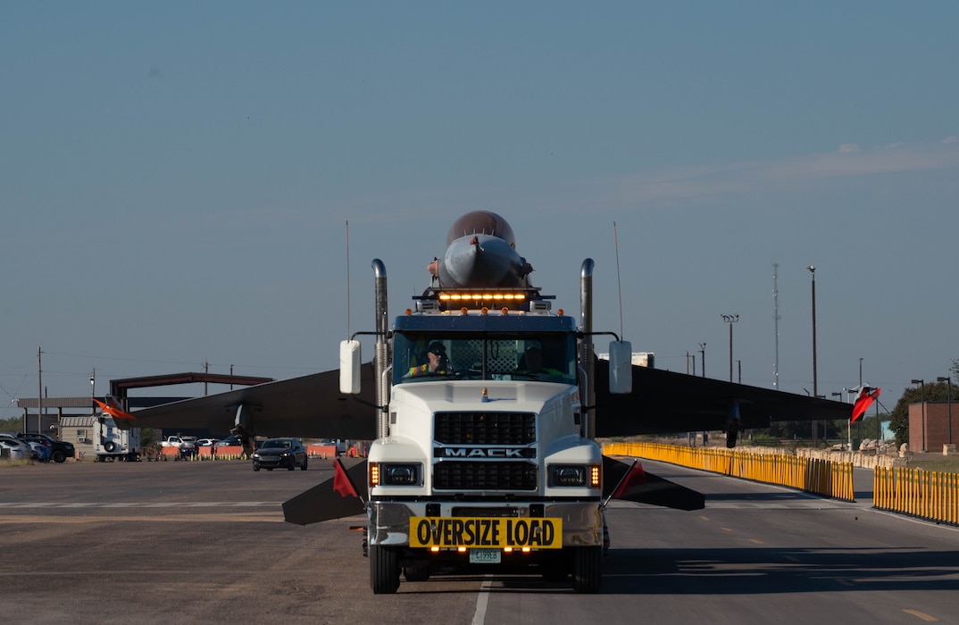 An F-16 is being transported via ground to the Louis F. Garland Department of War Fire Academy.