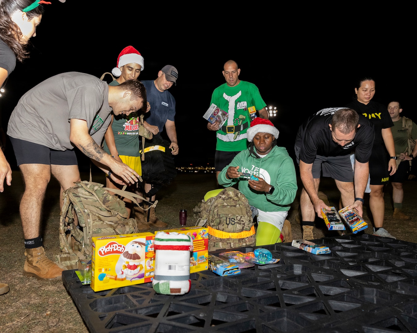 U.S. Army Soldiers from the Medical Readiness Battalion, Hawaii gather for a group photo during the holiday ruck event at Tripler Army Medical Center on Dec. 12, 2025. The event brought together approximately 40 to 50 participants who donated an estimated 300 toys to brighten the holiday season for admitted pediatric patients in the 7B1 ward, the Pediatric Intensive Care Unit, children attending neurology, dermatology, endocrinology, and allergy clinics. (DHA photo by Crizalmer Caraang Jr)