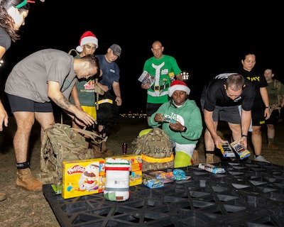 U.S. Army Soldiers from the Medical Readiness Battalion, Hawaii gather for a group photo during the holiday ruck event at Tripler Army Medical Center on Dec. 12, 2025. The event brought together approximately 40 to 50 participants who donated an estimated 300 toys to brighten the holiday season for admitted pediatric patients in the 7B1 ward, the Pediatric Intensive Care Unit, children attending neurology, dermatology, endocrinology, and allergy clinics. (DHA photo by Crizalmer Caraang Jr)