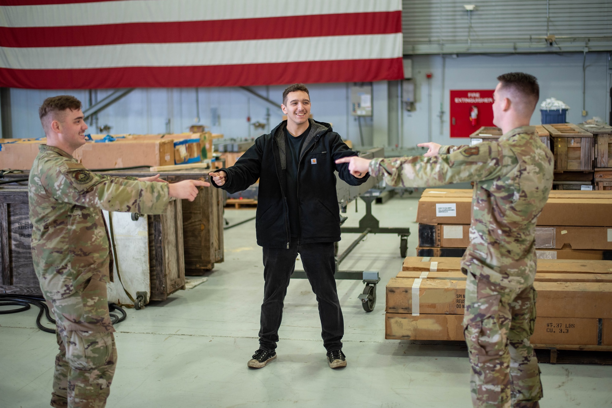 Three brothers: Senior Airman Eithan Rush (left), 142nd Maintenance Squadron (MXS), Airman 1st Class Wyatt Rush (right), 142nd Aircraft Maintenance Squadron, and Jayden Mancilla, a new recruit coming into the propulsion flight in the 142nd MXS, pose in the famous “Spider-Man meme” pose at Portland Air National Guard Base, Portland, Ore., Dec. 6, 2025.