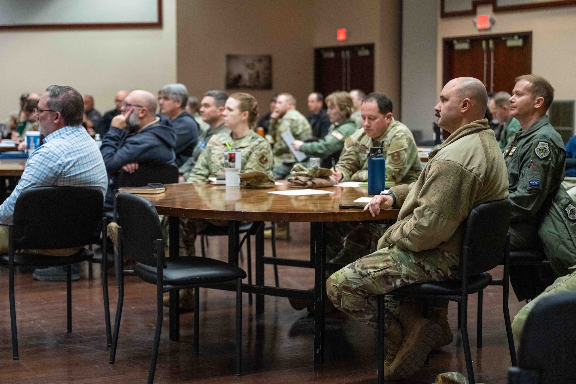 Altus Air Force Base leadership listen to a presentation during the civil law symposium at Altus Air Force Base, Oklahoma, Dec. 8,2025. Civil law symposiums are crucial for Air Force leaders because they ensure commanders can make sound decisions, maintain discipline, and navigate global legal landscapes. (U.S. Air Force photo by Airman1st Class Nathan Langston)