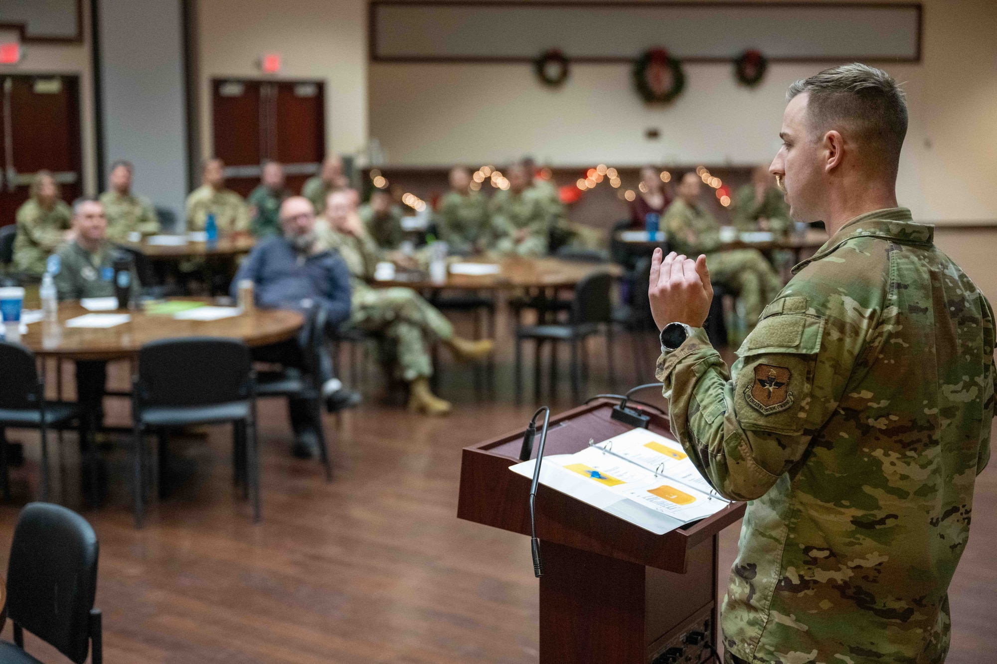 U.S. Air Force Capt. Heath Schintler, 97thAir Mobility Wing civil law chief, leads a presentation for a civil law symposium brief at Altus Air Force Base, Oklahoma, Dec. 8,2025. Schintler covered a wide range of topics surrounding civil law as one of the speakers for the symposium. (U.S. Air Force photo by Airman 1st Class Nathan Langston)